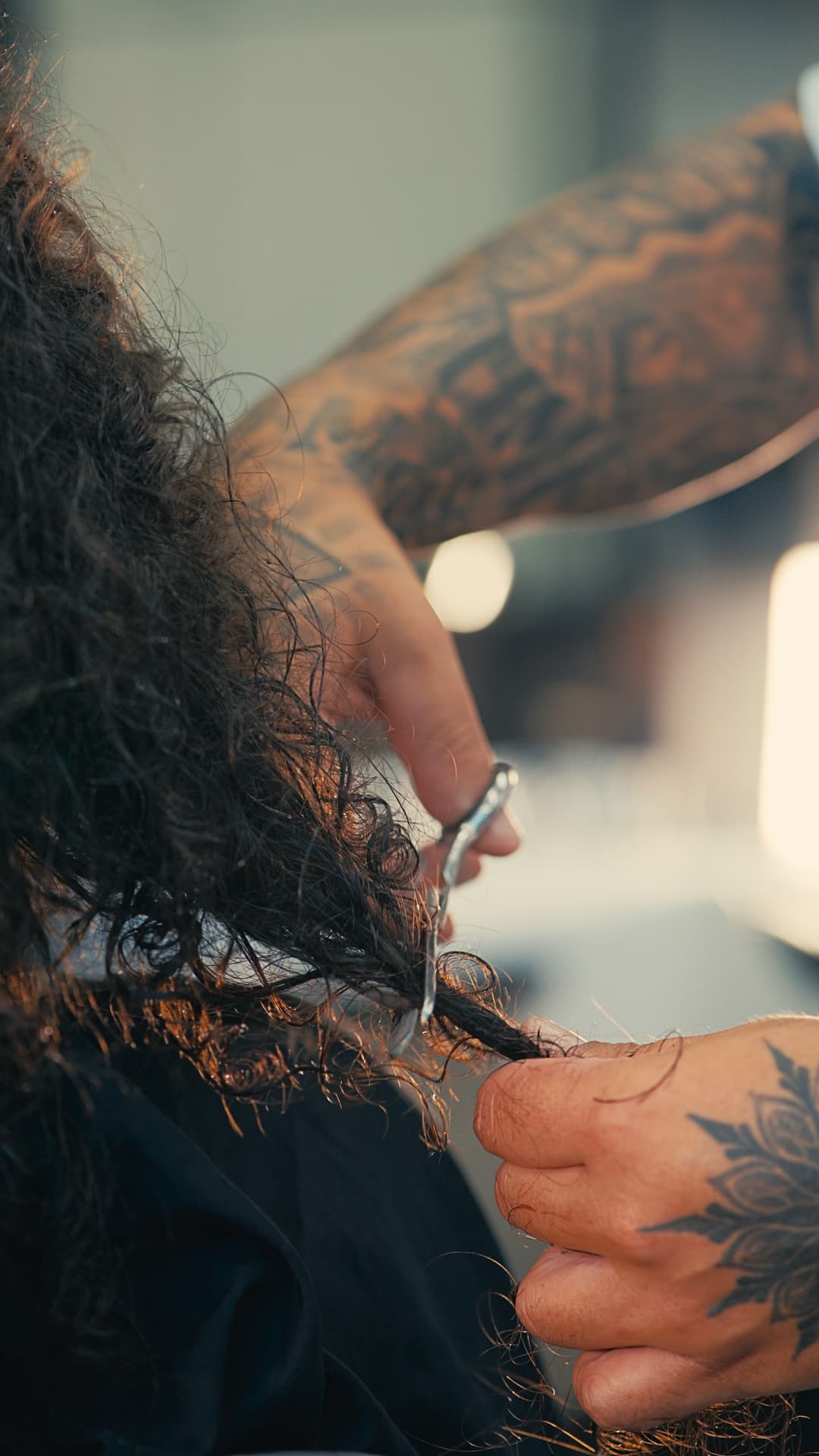 Precision scissor work on curly hair at Success Barbershop
